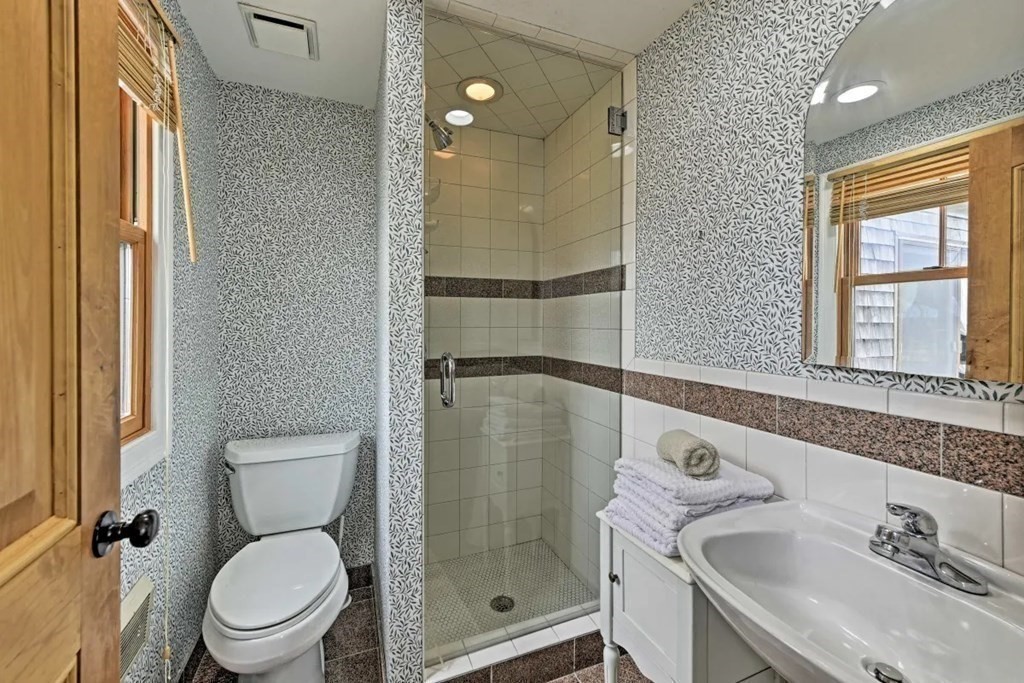 232 Lagoon Pond Road Tisbury, MA 02568 - Photo 22 of 31 a bathroom with a sink toilet and shower