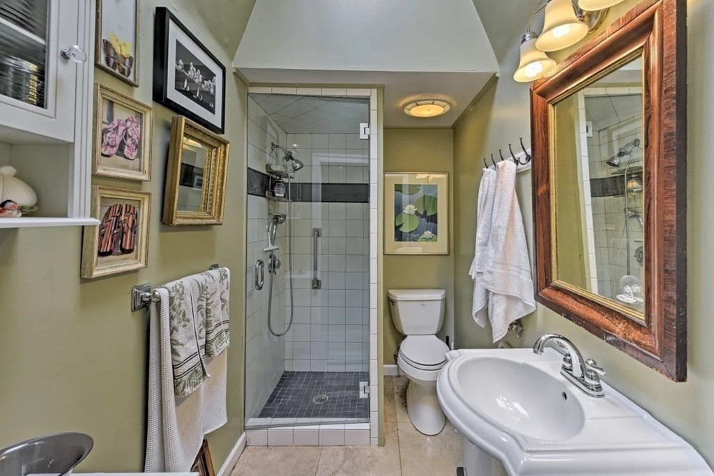 232 Lagoon Pond Road Tisbury, MA 02568 - Photo 26 of 31 a bathroom with a sink a toilet a mirror and shower