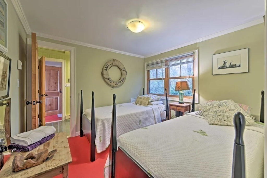 232 Lagoon Pond Road Tisbury, MA 02568 - Photo 27 of 31 a living room with furniture a large window and a clock