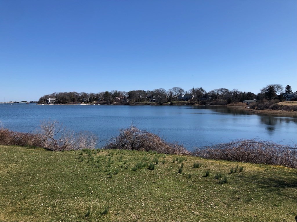 232 Lagoon Pond Road Tisbury, MA 02568 - Photo 31 of 31 a view of a lake with houses in the back