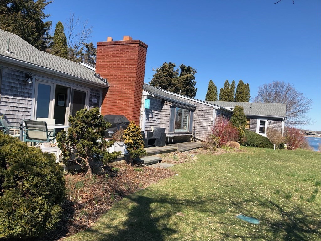 232 Lagoon Pond Road Tisbury, MA 02568 - Photo 4 of 31 front view of a house with a yard
