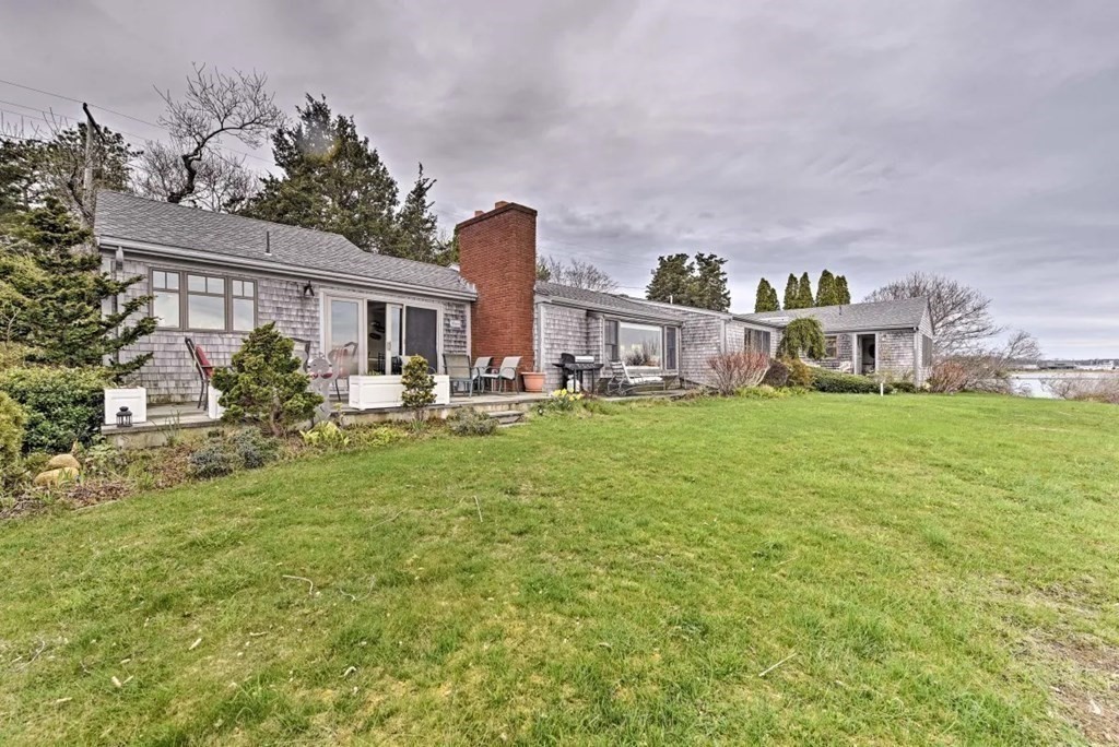 232 Lagoon Pond Road Tisbury, MA 02568 - Photo 6 of 31 a view of a house with a big yard and potted plants in front of the house