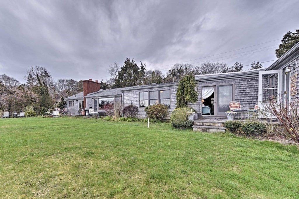 232 Lagoon Pond Road Tisbury, MA 02568 - Photo 7 of 31 a view of a house with backyard sitting area and garden