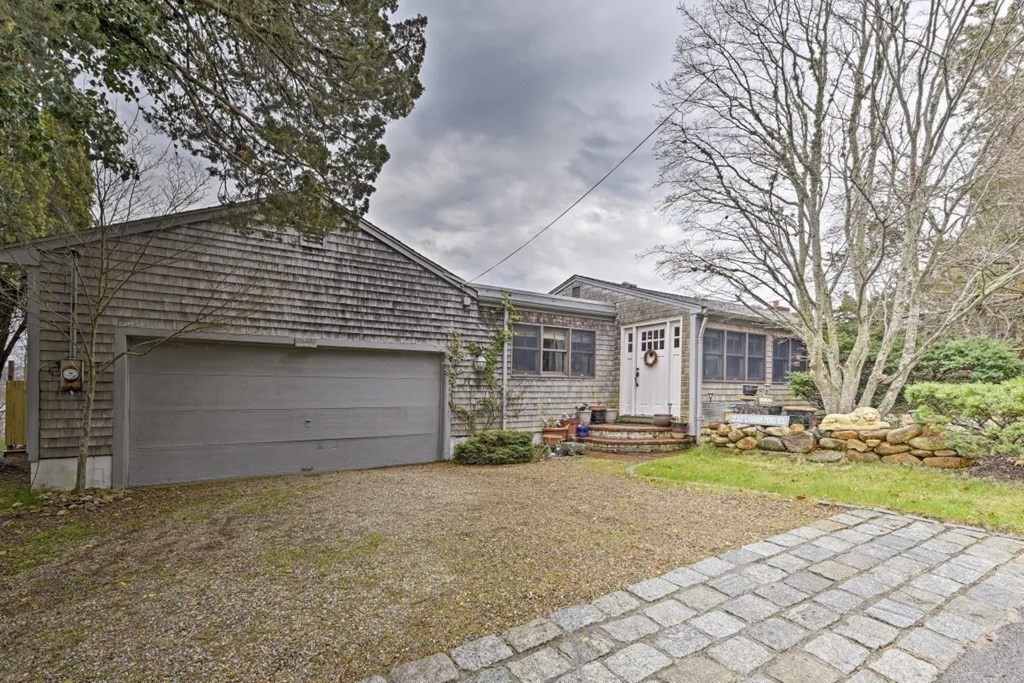232 Lagoon Pond Road Tisbury, MA 02568 - Photo 8 of 31 a front view of a house with a yard and garage