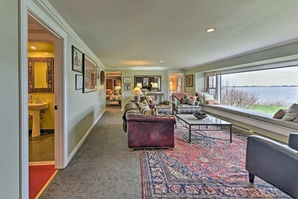 232 Lagoon Pond Road Tisbury, MA 02568 - Photo 10 of 31 a living room with furniture and a floor to ceiling window