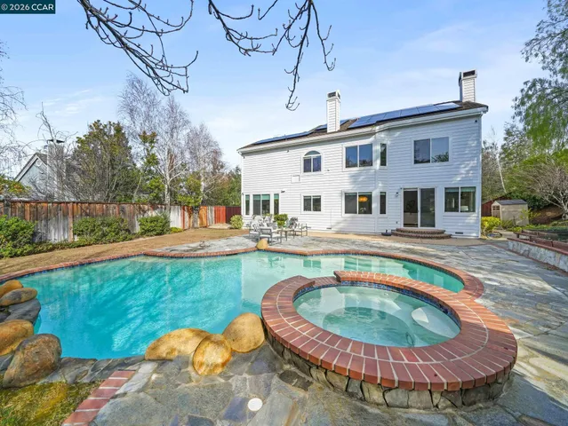 an aerial view of a house with a yard and garden