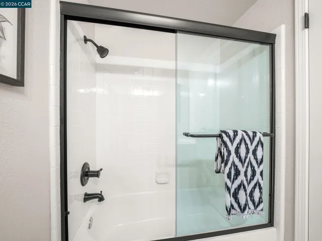 a view of a backyard with chairs and a large tree