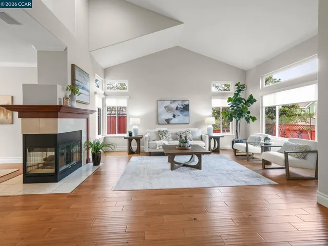 a living room with fireplace furniture and a wooden floor