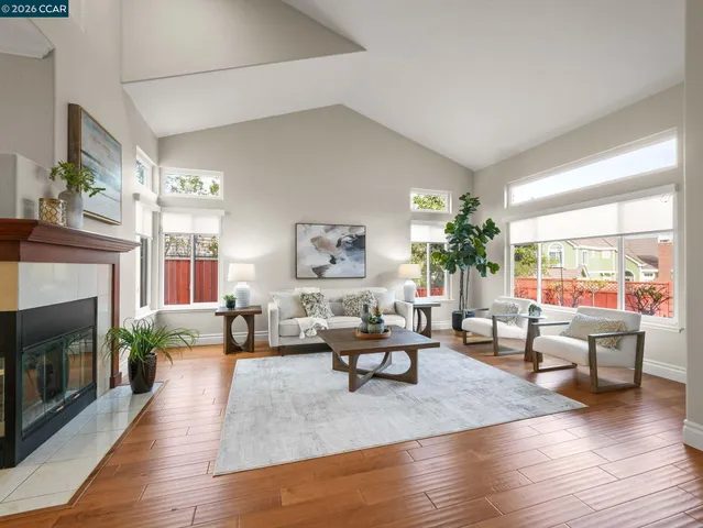 a living room with fireplace furniture and a wooden floor