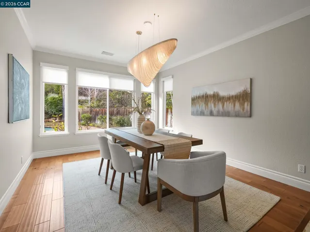 a kitchen with stainless steel appliances wooden cabinets a stove a refrigerator and island with wooden floor