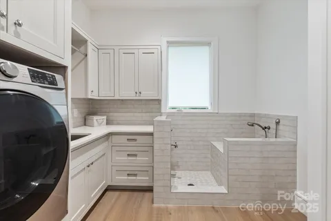 a kitchen with granite countertop a sink a stove and cabinets