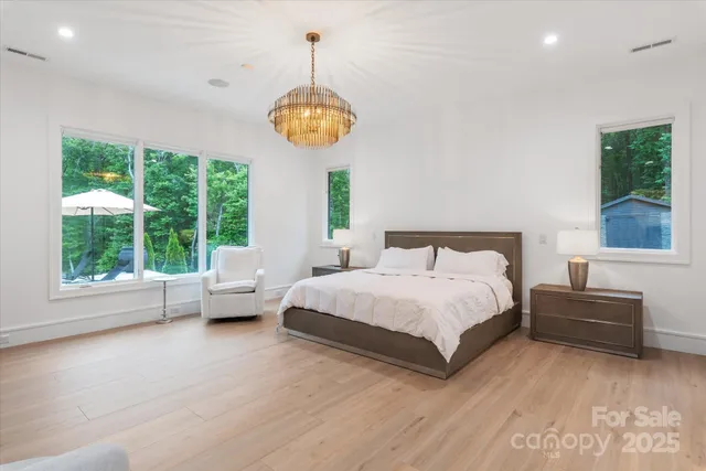 a spacious bedroom with a bed and a large window