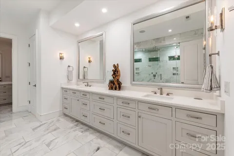 a bathroom with double sink and a mirror