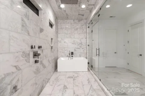 a bathroom with a sink vanity mirror and shower