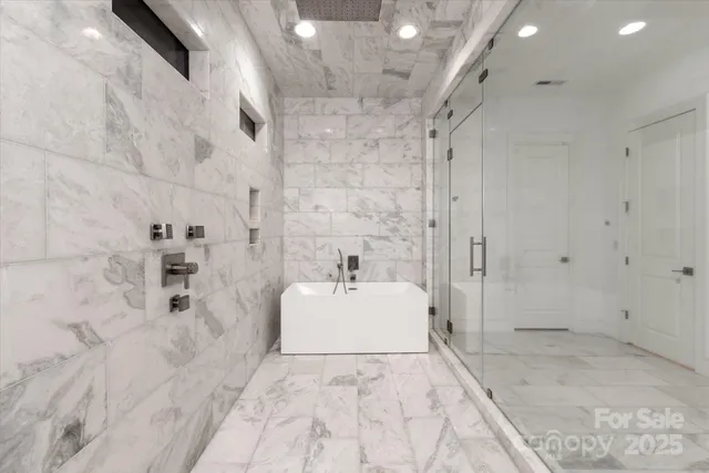 a bathroom with a sink vanity mirror and shower