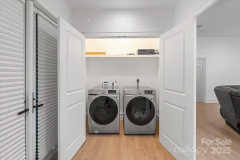 a view of a hallway with washer and dryer