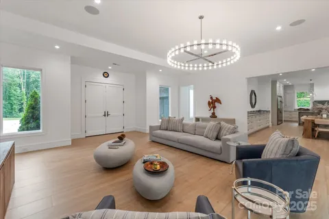a living room with furniture and a chandelier