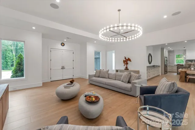 a living room with furniture and a chandelier
