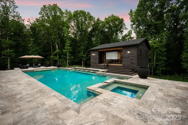 a view of a backyard with swimming pool