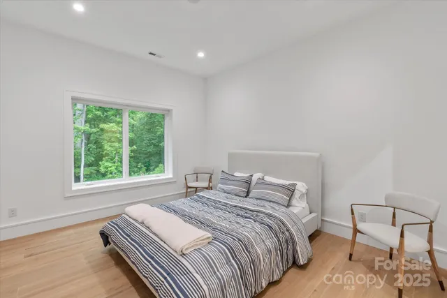 a bedroom with a bed and a chair