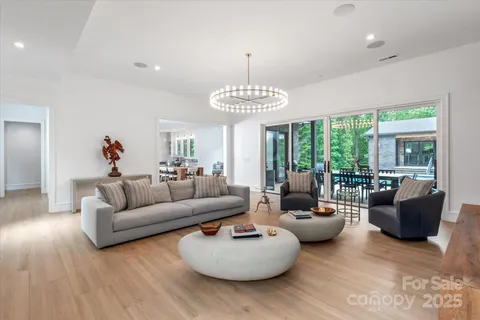a living room with furniture and a chandelier