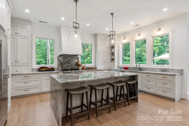 a kitchen with center island table and chairs