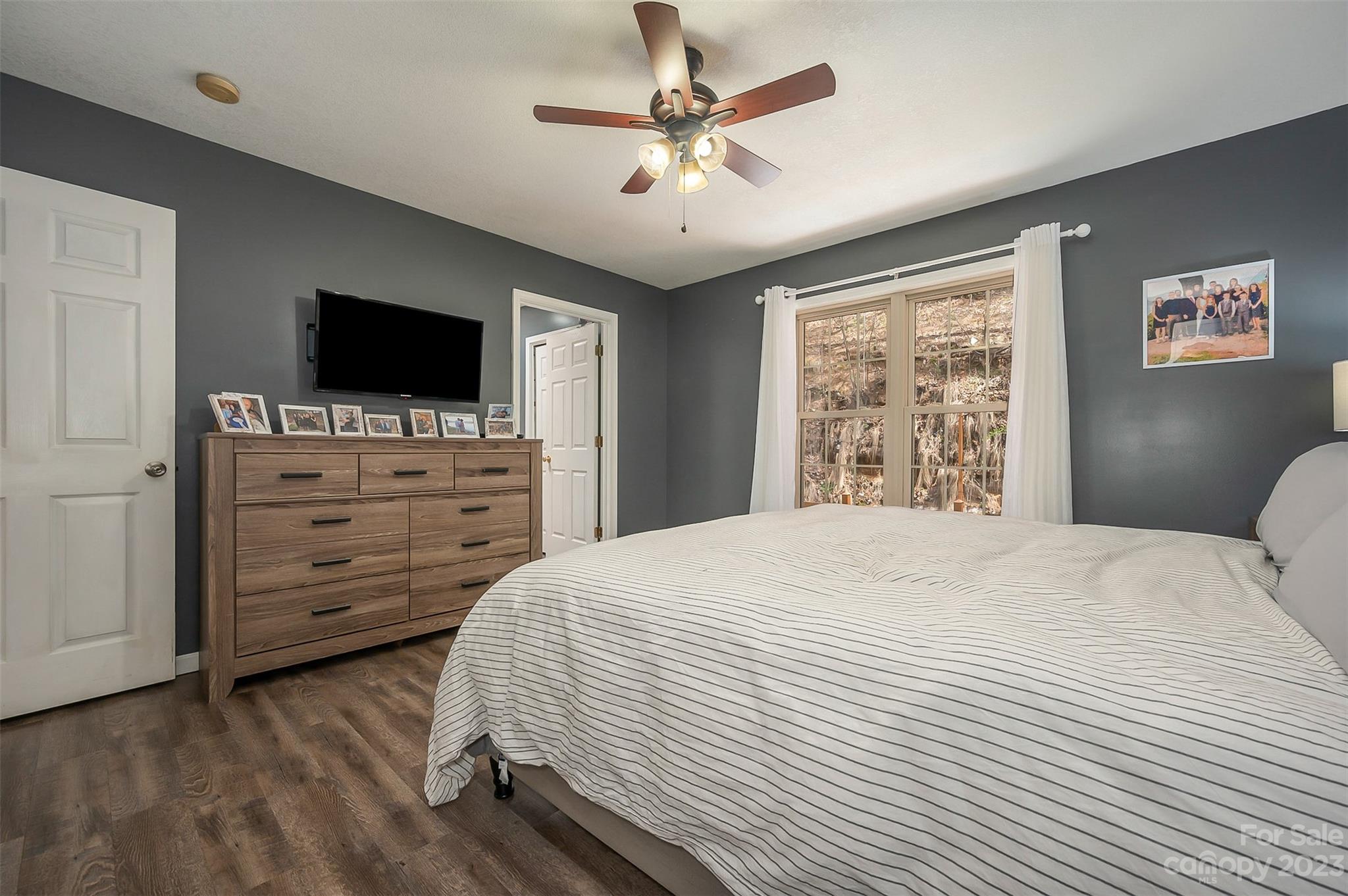 1251 Terrys Creek Road Zirconia, NC 28790 - Photo 20 of 48 a bedroom with a bed and a flat screen tv