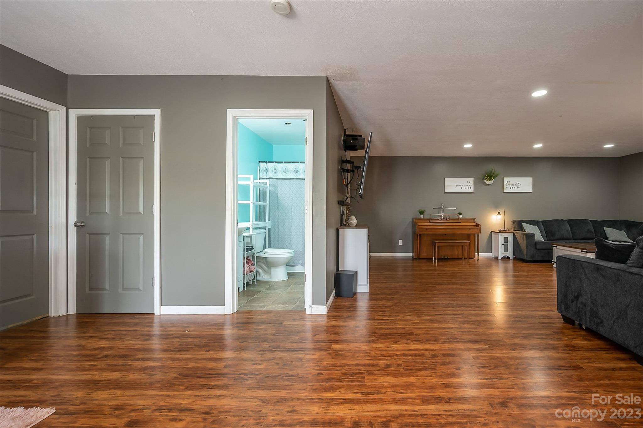 1251 Terrys Creek Road Zirconia, NC 28790 - Photo 26 of 48 a view of a living room with kitchen island granite countertop wooden floor and a view of living room