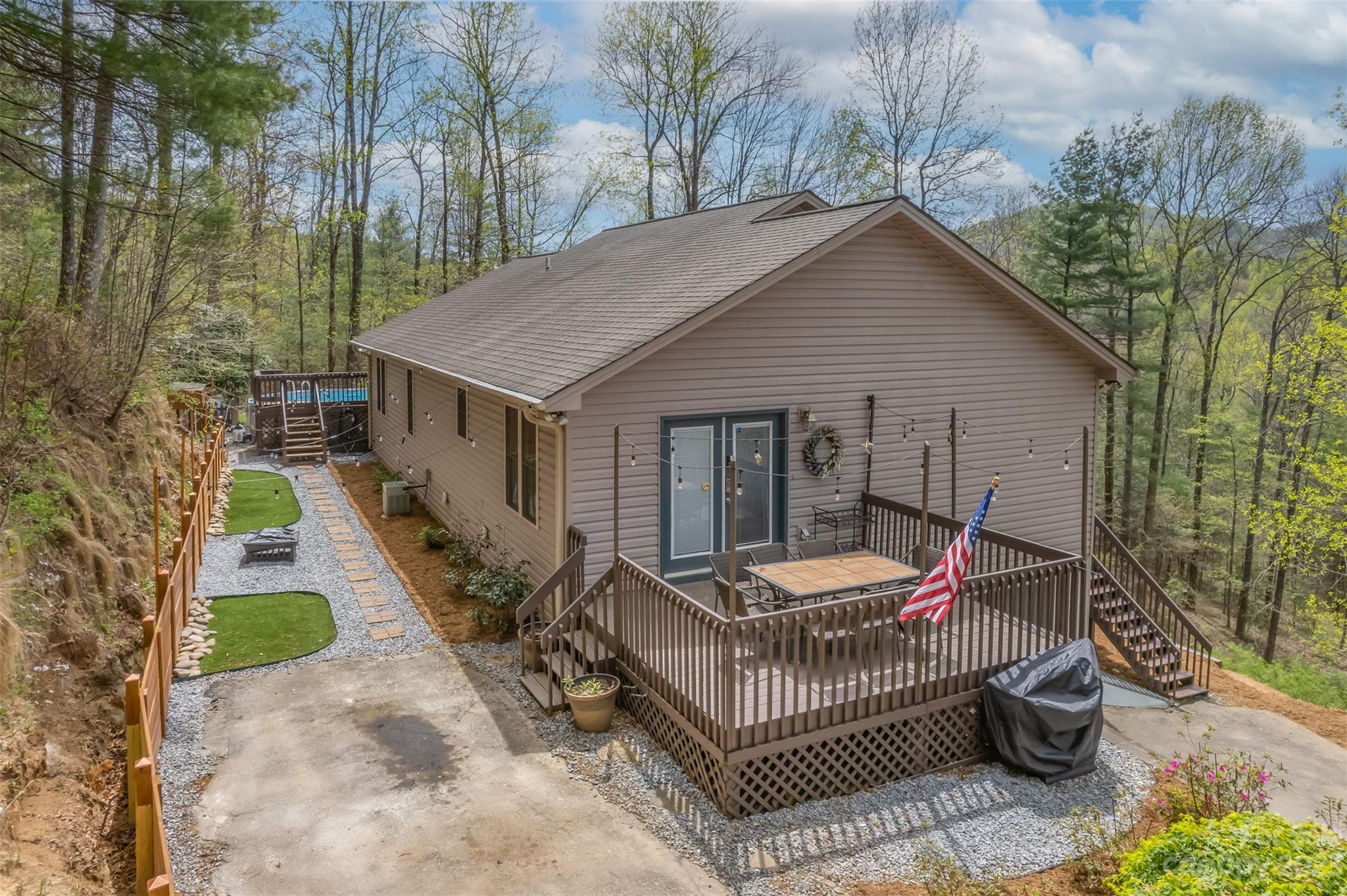 1251 Terrys Creek Road Zirconia, NC 28790 - Photo 3 of 48 a view of a house with a small yard and furniture