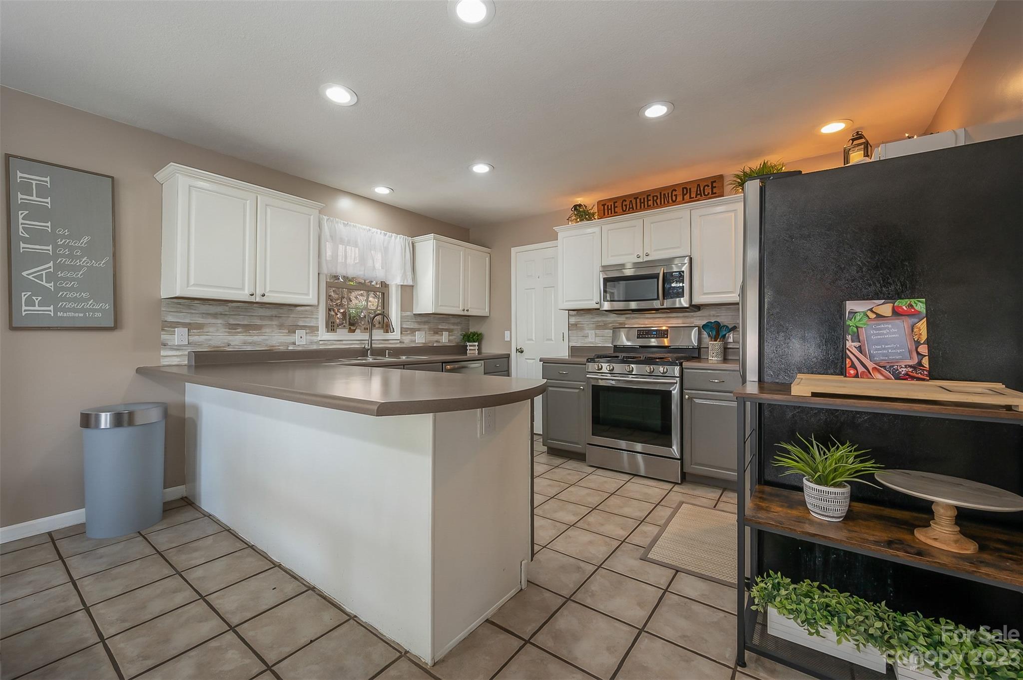 1251 Terrys Creek Road Zirconia, NC 28790 - Photo 6 of 48 a kitchen with stainless steel appliances granite countertop a stove a sink and a refrigerator