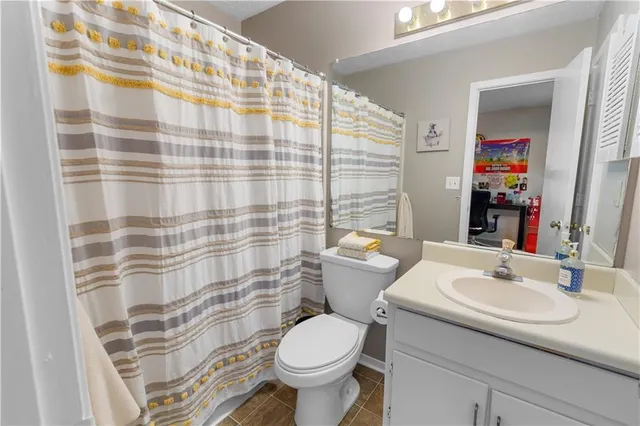 a bedroom with furniture and a lamp