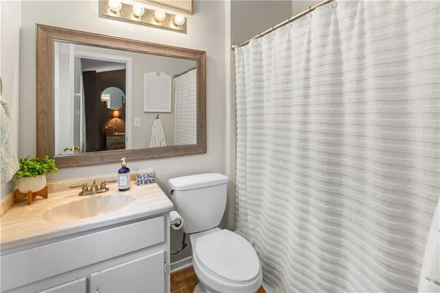 a bedroom with a bed and a flat tv screen on dresser