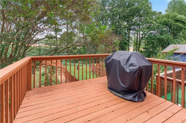 a living room with furniture a potted plant and a large window