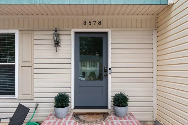 a view of a porch with a table and chairs