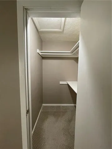 an empty room with window in bathroom