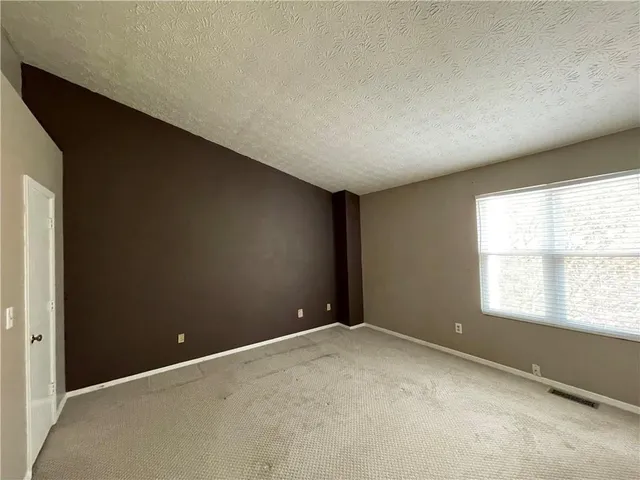 an empty room with a empty space and windows