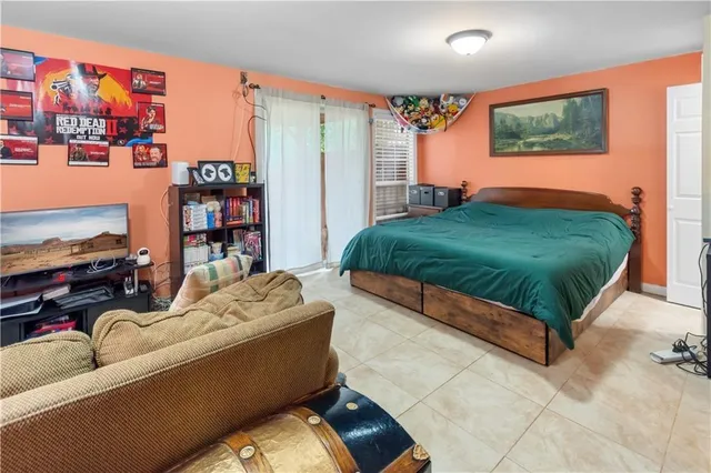 a living room with furniture and book shelf
