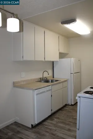 a kitchen with a sink cabinets and appliances