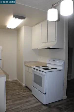 a kitchen with cabinets and a wooden floor