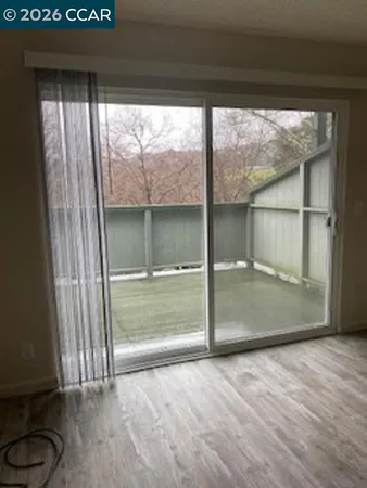 a view of a glass door with a yard