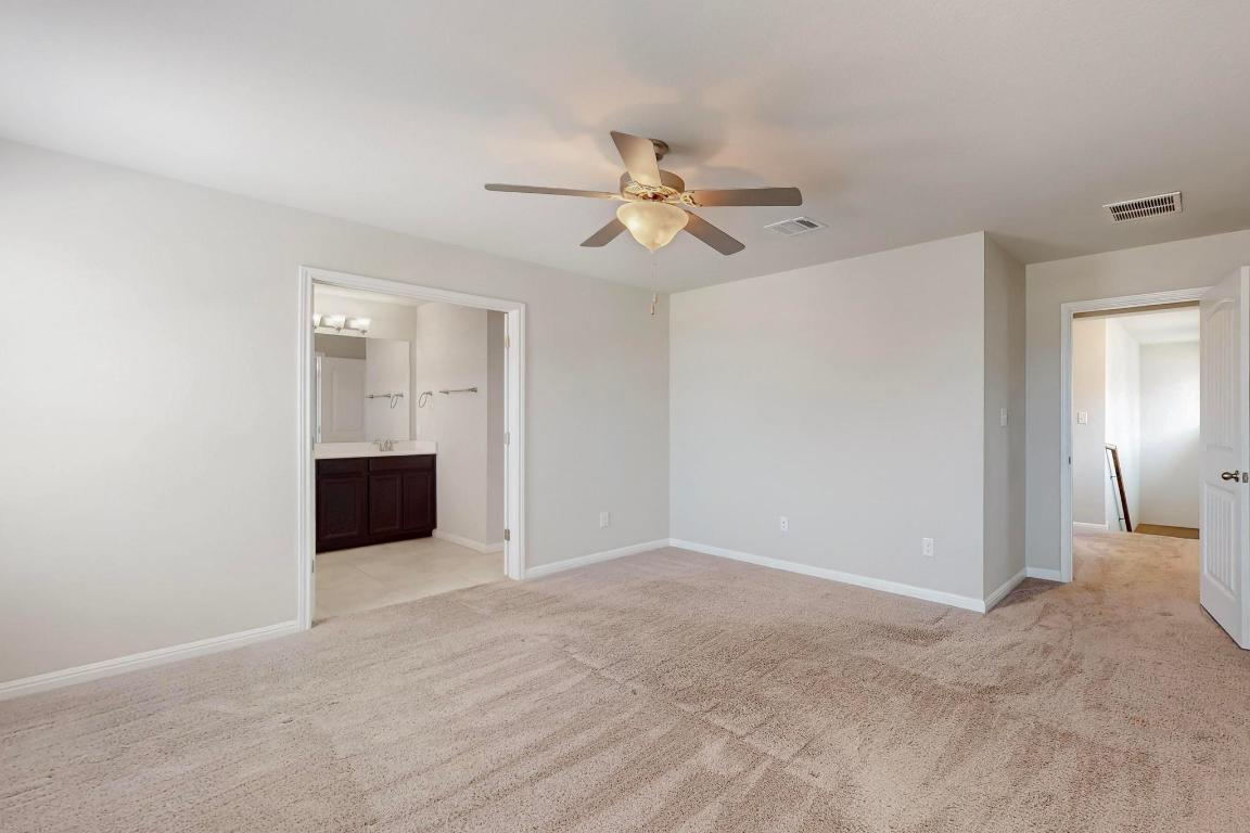 2908 Harvester Lane Round Rock, TX 78664 - Photo 19 of 40 a view of an empty room with a ceiling fan