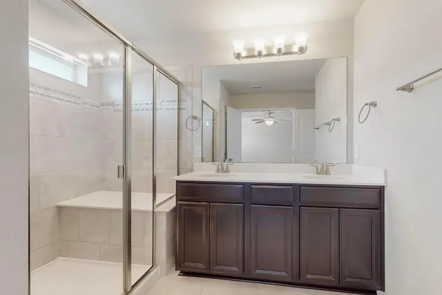 a bathroom with a double vanity sink and mirror