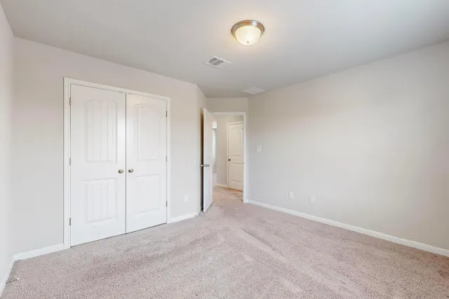 a view of an empty room and closet area