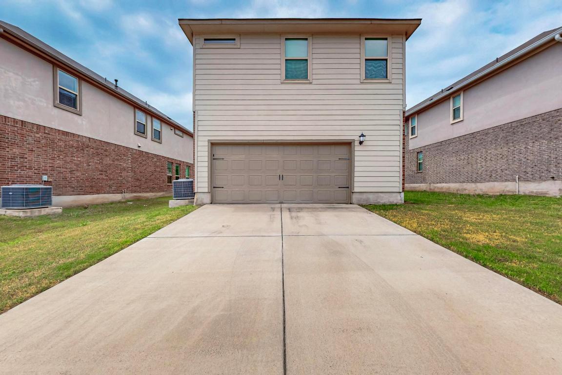 2908 Harvester Lane Round Rock, TX 78664 - Photo 35 of 40 a white house that has a small yard and parking space