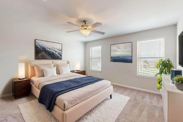 a bedroom with bed and a potted plant
