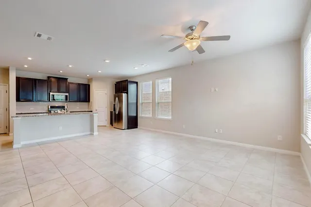 a view of an empty room with a kitchen