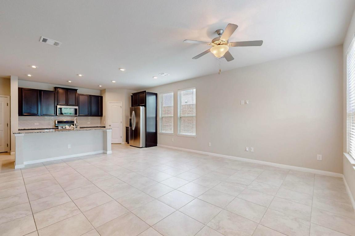 2908 Harvester Lane Round Rock, TX 78664 - Photo 7 of 40 a view of an empty room with a kitchen