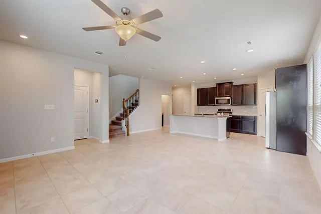 a view of a kitchen with a sink and a ceiling fan