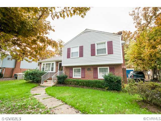 6433 Commander Road Richmond, VA 23224 - Photo 12 of 21 a front view of a house with a yard