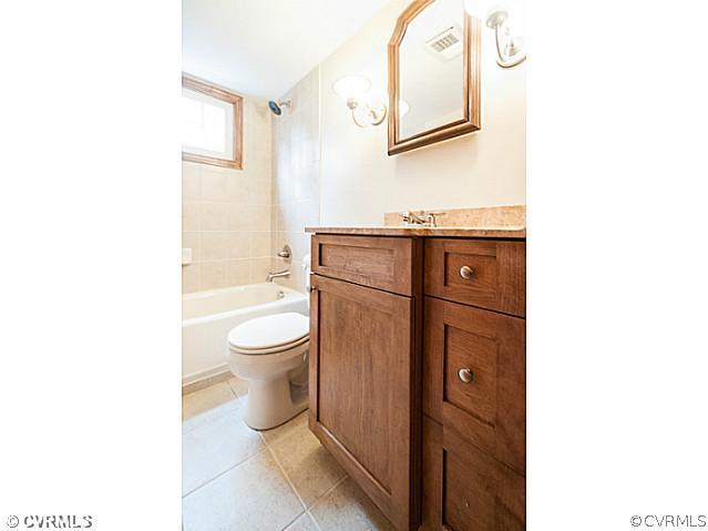 6433 Commander Road Richmond, VA 23224 - Photo 4 of 21 a bathroom with a toilet a sink and a mirror